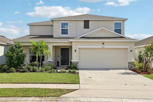 front facade featuring a garage and a front lawn