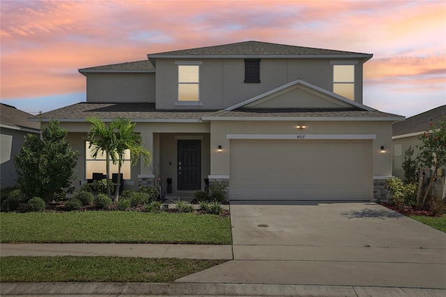 view of front of house featuring a lawn and a garage