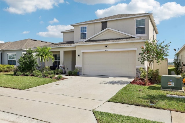 view of property featuring a garage and a front lawn