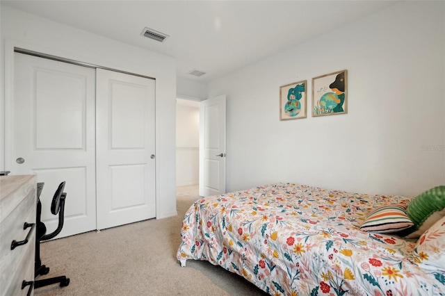 bedroom featuring light carpet and a closet