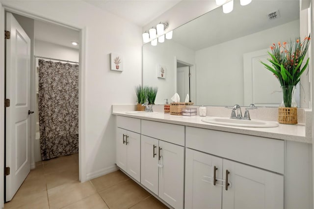 bathroom with tile patterned floors, vanity, and walk in shower