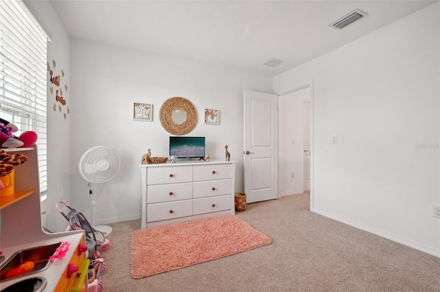 bedroom featuring light colored carpet