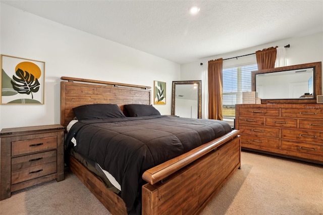 carpeted bedroom featuring a textured ceiling