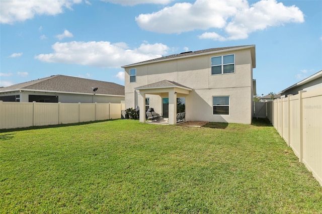 back of property featuring a yard and a patio