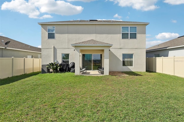 back of property featuring a patio area and a yard