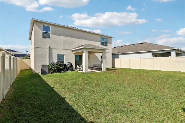 back of house featuring a patio area, a yard, and cooling unit