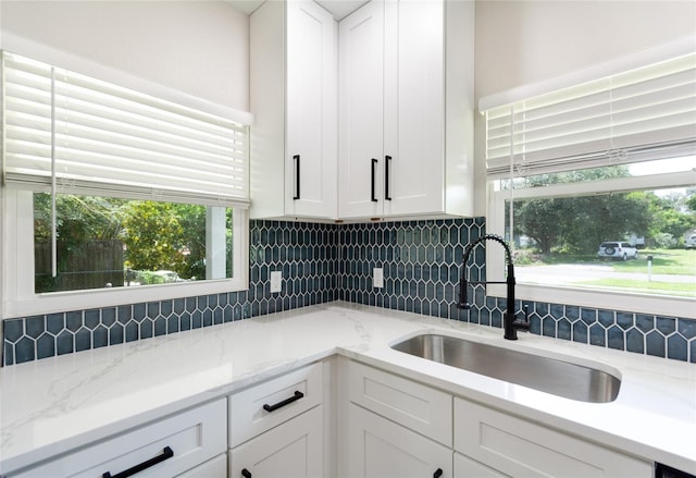 kitchen featuring white cabinets, sink, and plenty of natural light