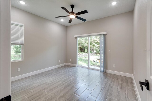 spare room with ceiling fan and light hardwood / wood-style floors