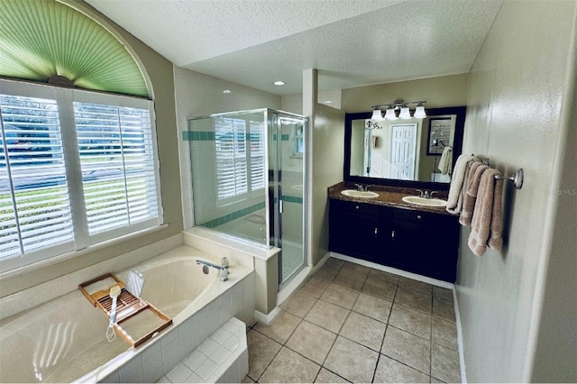 bathroom featuring tile patterned flooring, shower with separate bathtub, a textured ceiling, and vanity