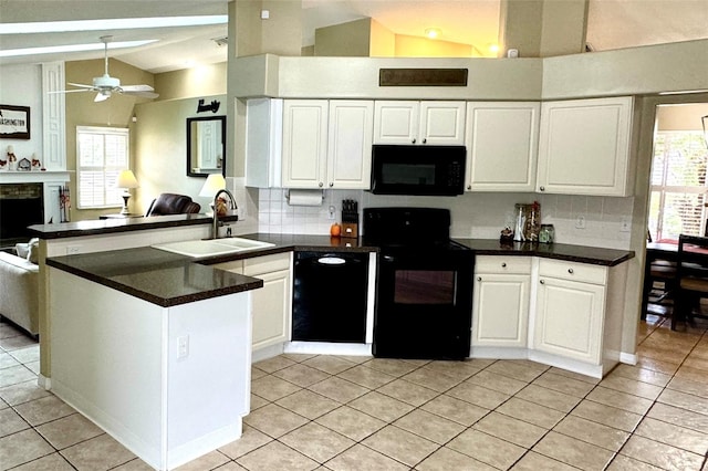 kitchen with black appliances, kitchen peninsula, ceiling fan, a healthy amount of sunlight, and white cabinetry