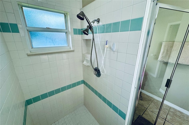 bathroom featuring tile patterned flooring and a shower with shower door