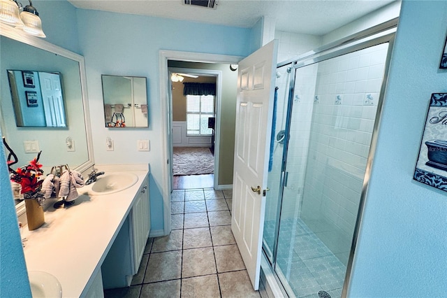 bathroom featuring vanity, tile patterned floors, and an enclosed shower