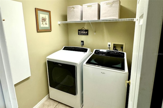 clothes washing area with light tile patterned floors and washing machine and clothes dryer