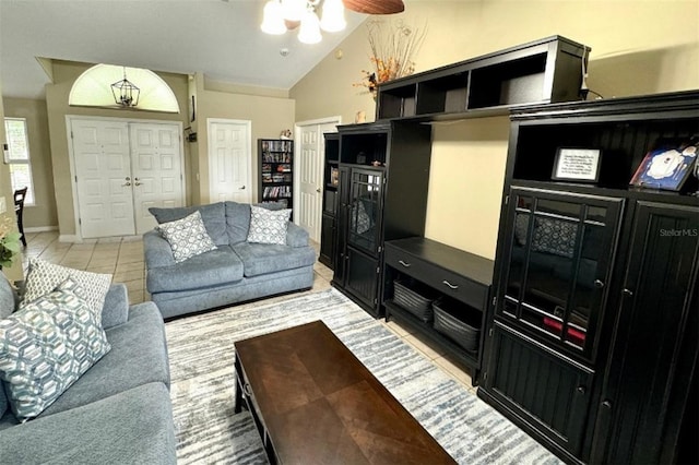 tiled living room featuring ceiling fan and lofted ceiling