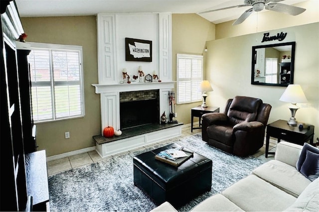 living room featuring light tile patterned floors, a large fireplace, ceiling fan, and lofted ceiling