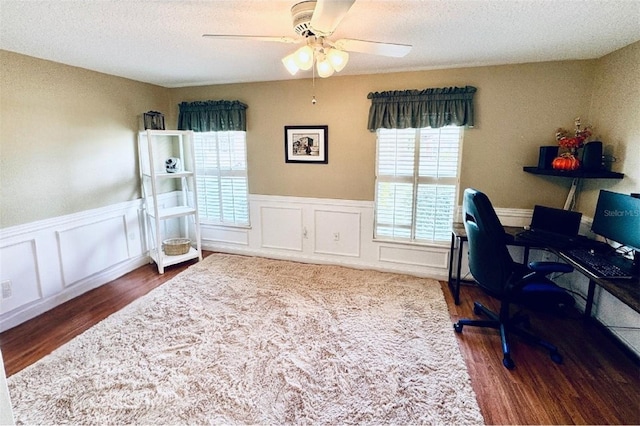 office space featuring a textured ceiling, ceiling fan, and dark hardwood / wood-style floors