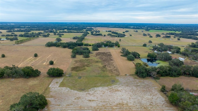 birds eye view of property with a water view and a rural view