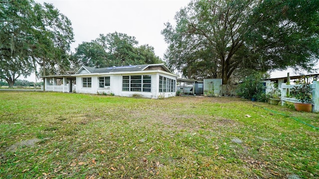 back of property featuring a lawn