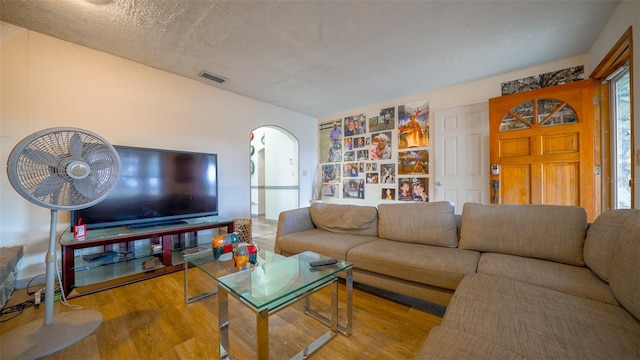 living room featuring a textured ceiling and hardwood / wood-style flooring