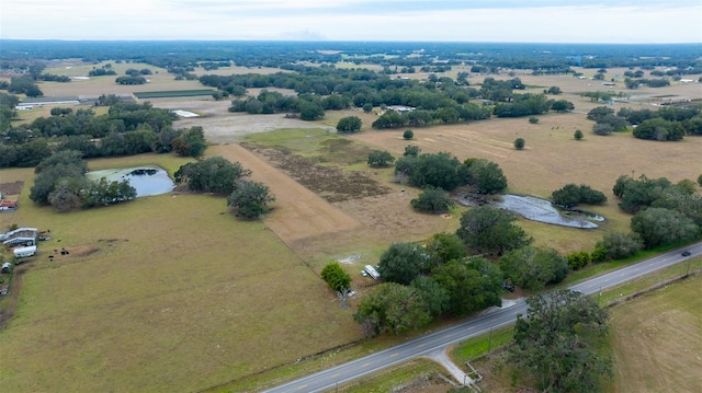 bird's eye view featuring a water view and a rural view