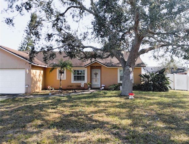 single story home featuring a front lawn and a garage