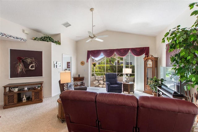 carpeted living room with ceiling fan and lofted ceiling