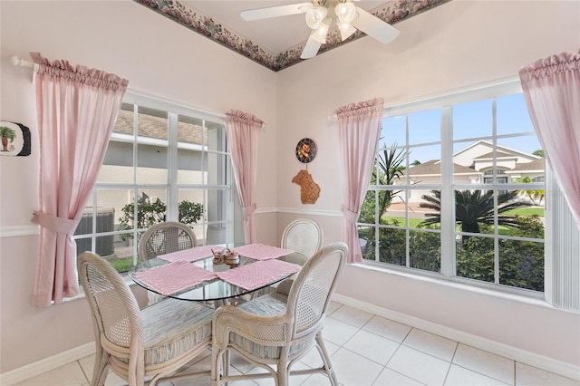 tiled dining space featuring ceiling fan and plenty of natural light