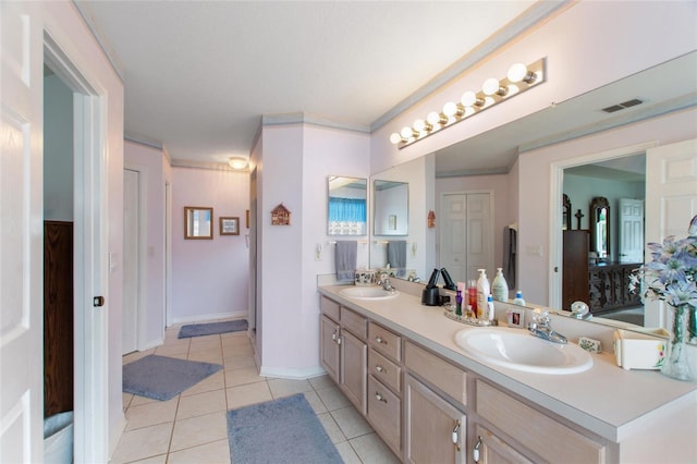 bathroom with tile patterned flooring, vanity, and ornamental molding