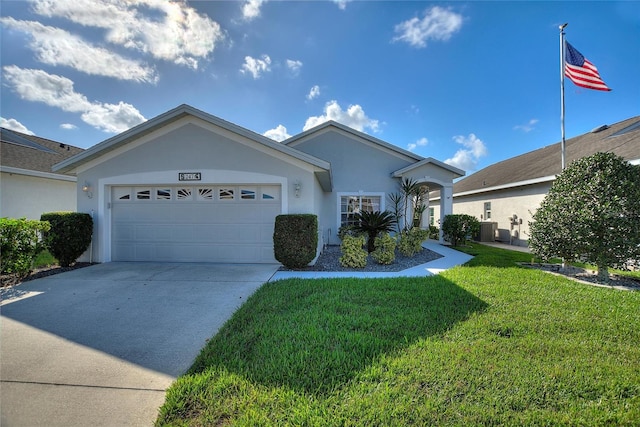 ranch-style home featuring a front yard, a garage, and cooling unit