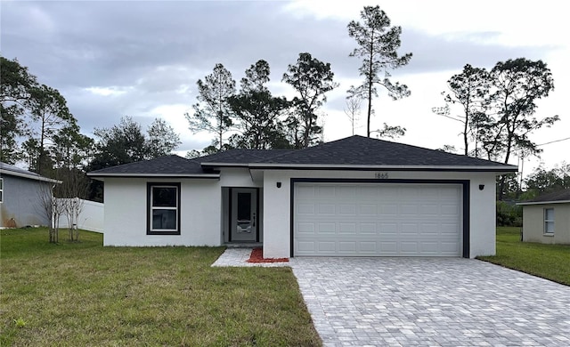 view of front of house with a garage and a front yard