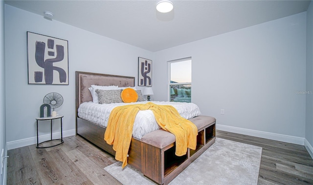 bedroom with wood-type flooring