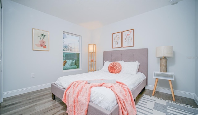 bedroom with hardwood / wood-style floors