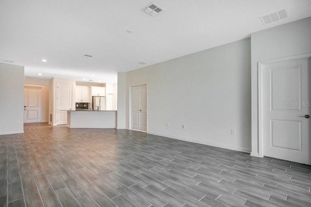 unfurnished living room featuring wood-type flooring