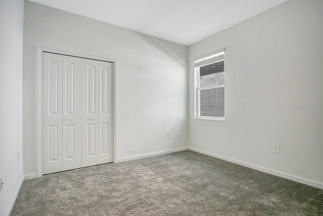 2971 Camden Way, Davenport, FL 33837 - unfurnished bedroom with carpet flooring, a closet, and baseboards