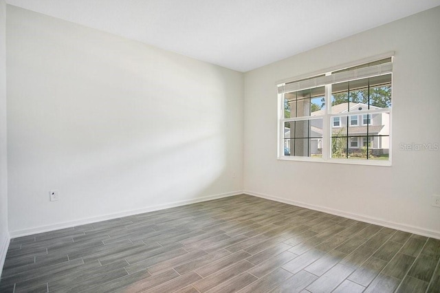 spare room with dark hardwood / wood-style floors