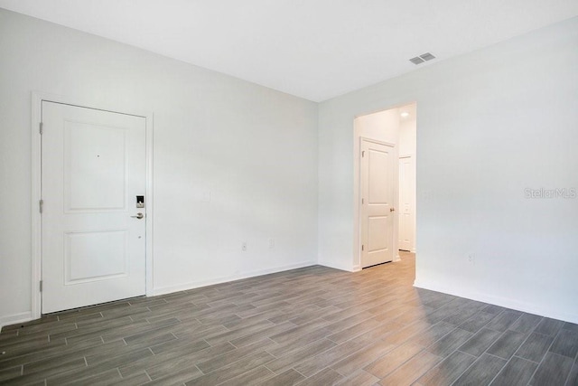 spare room featuring dark wood-type flooring