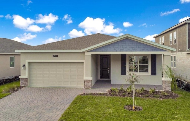 view of front of property featuring a front lawn and a garage