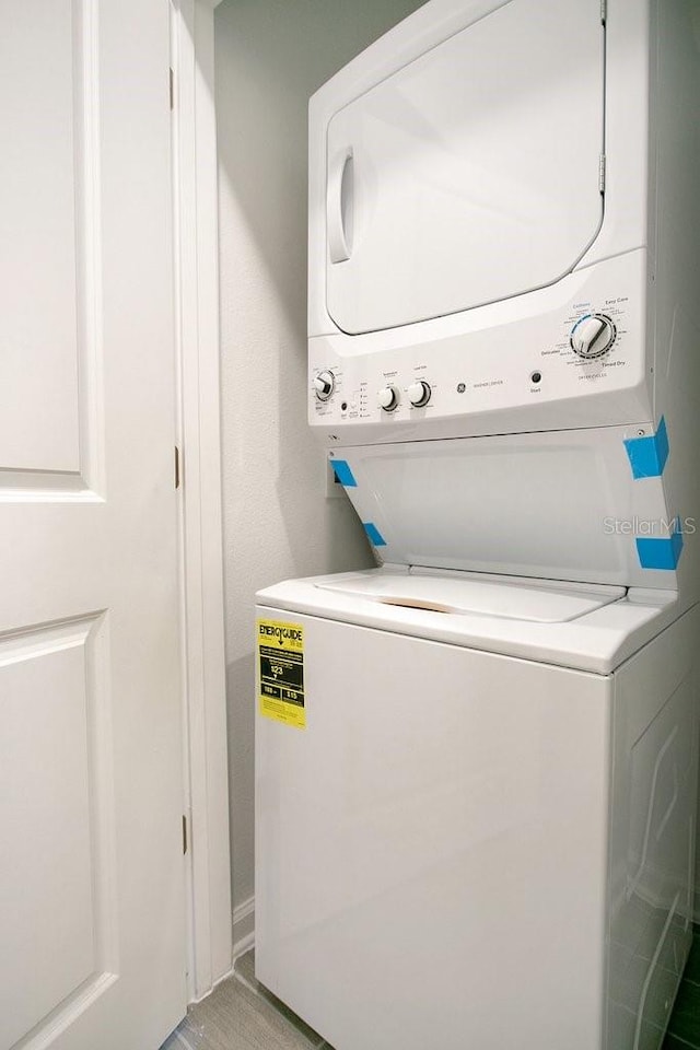 laundry room with stacked washer / drying machine