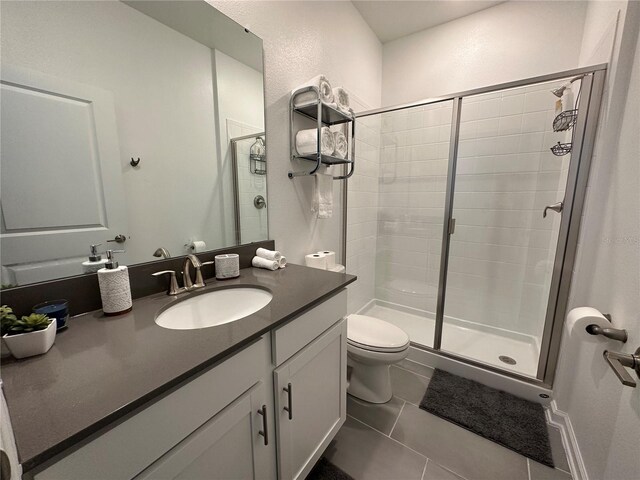 2971 Camden Way, Davenport, FL 33837 - full bathroom featuring a shower stall, toilet, vanity, and tile patterned flooring