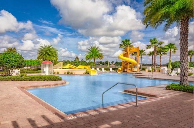 view of pool featuring a patio and a water slide