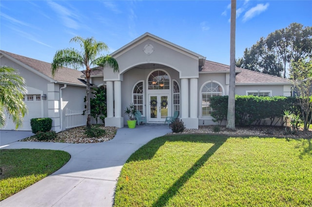 ranch-style house with french doors, a front lawn, and a garage