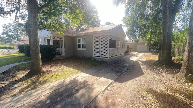 view of front facade featuring a garage and an outdoor structure