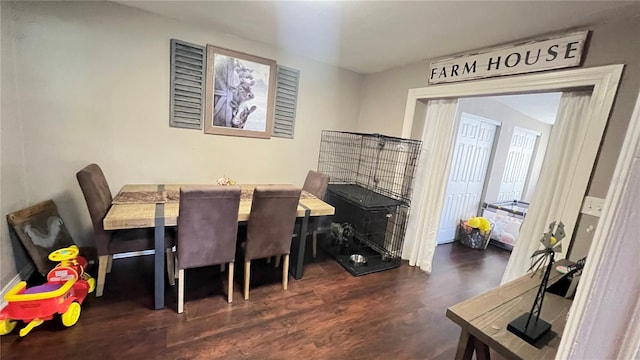 dining area featuring dark wood-type flooring