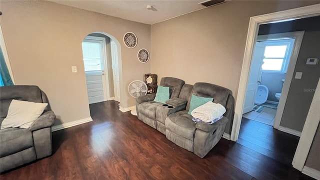 living room with dark hardwood / wood-style flooring