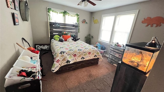 carpeted bedroom featuring ceiling fan and multiple windows