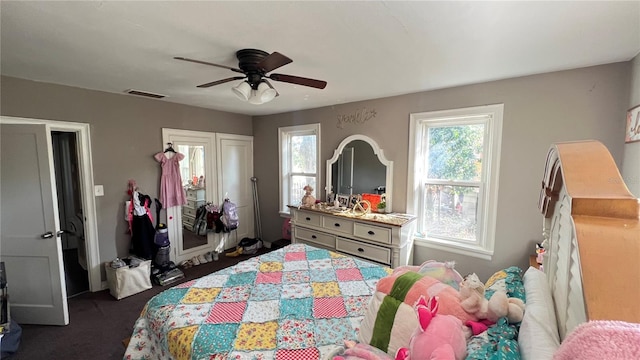 bedroom featuring ceiling fan and multiple windows