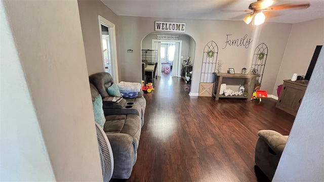 living room with ceiling fan and dark hardwood / wood-style floors