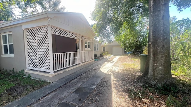 view of side of home with a garage and an outdoor structure