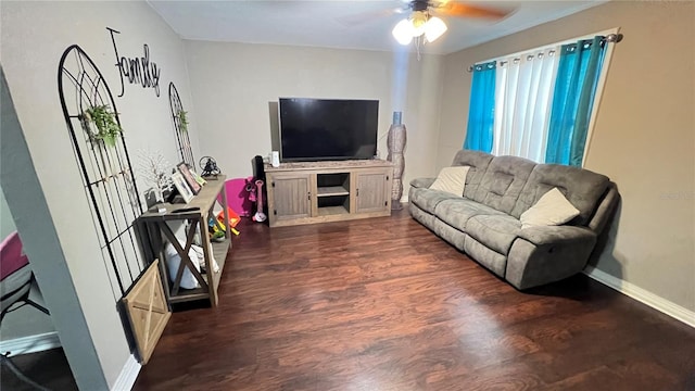 living room featuring ceiling fan and dark hardwood / wood-style flooring