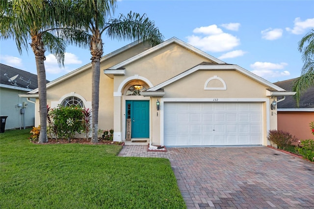 view of front of house with a front yard and a garage